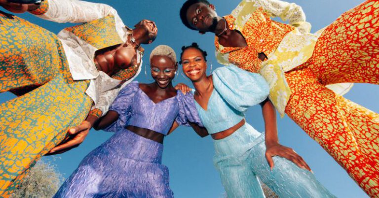 Traditional Attire - Low Angle View of Men and Women in Colorful Suits