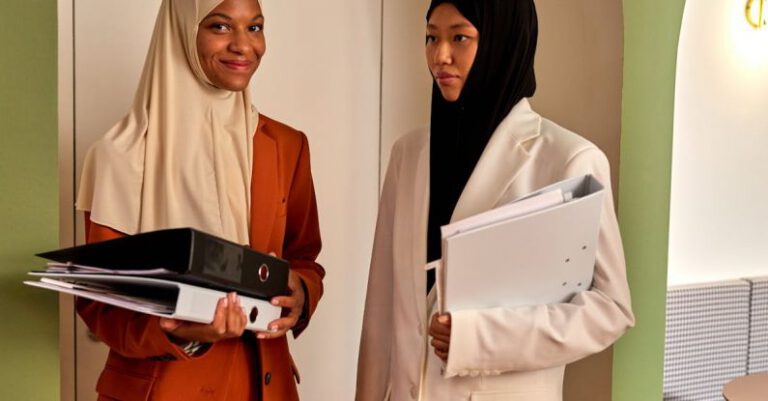 Dress Codes - Muslim Women in Hijabs Standing in Office Interior