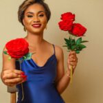 Gift Giving Customs - Woman in Blue Satin Dress Holding Red Roses