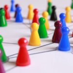 Networking - Close Up Photography of Yellow Green Red and Brown Plastic Cones on White Lined Surface