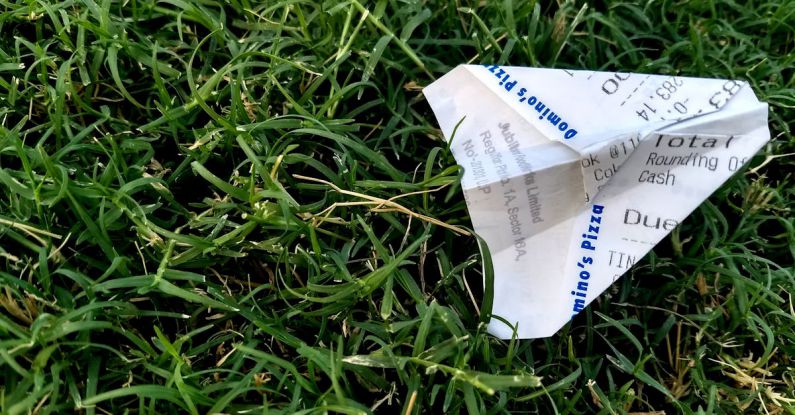 Receipts - Receipt Folded Into Paper Plane on Grass