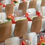 Corporate Event - Long Tables With White Cloths and Brown Chairs Formal Setting