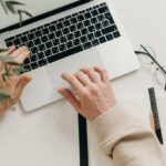 Productivity - Person in Beige Long Sleeve Shirt Using Macbook Pro